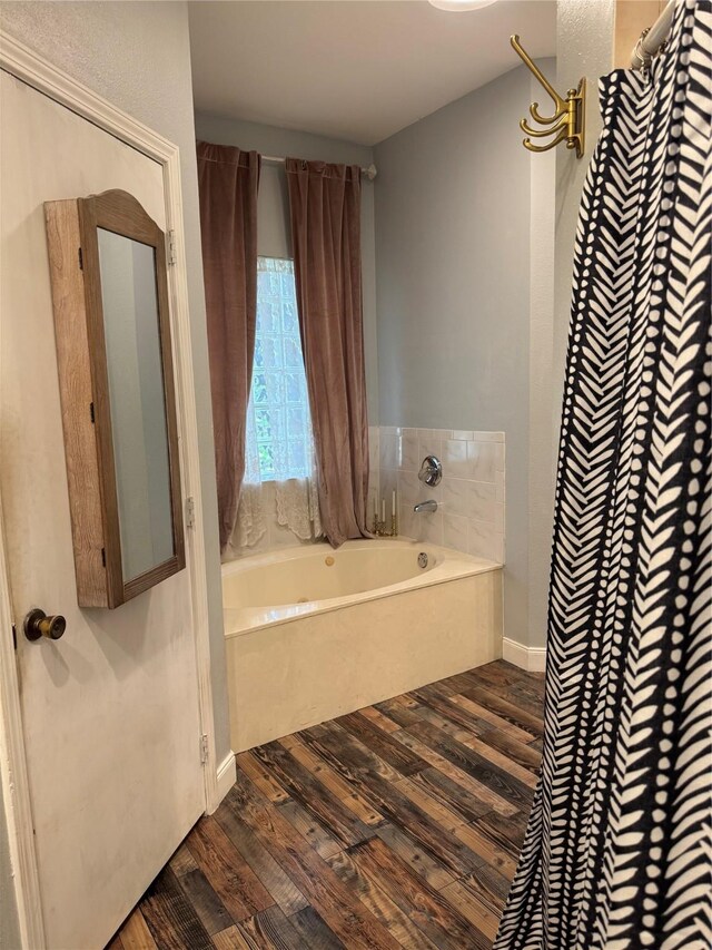 9010 Carousel Ln, Houston, TX 77080 - bathroom with wood finished floors and a garden tub