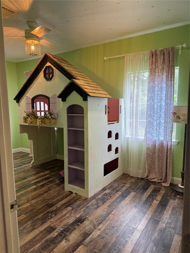 unfurnished room with a ceiling fan, a healthy amount of sunlight, and wood finished floors