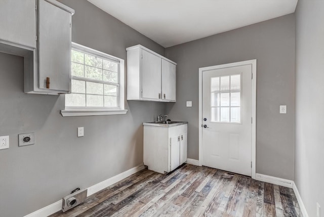 9010 Carousel Ln, Houston, TX 77080 - washroom with hookup for an electric dryer, cabinet space, and light wood-style flooring