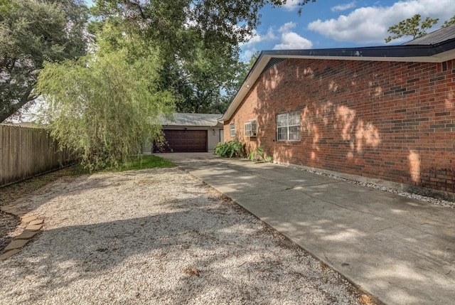 9010 Carousel Ln, Houston, TX 77080 - view of side of property featuring brick siding, driveway, and a garage