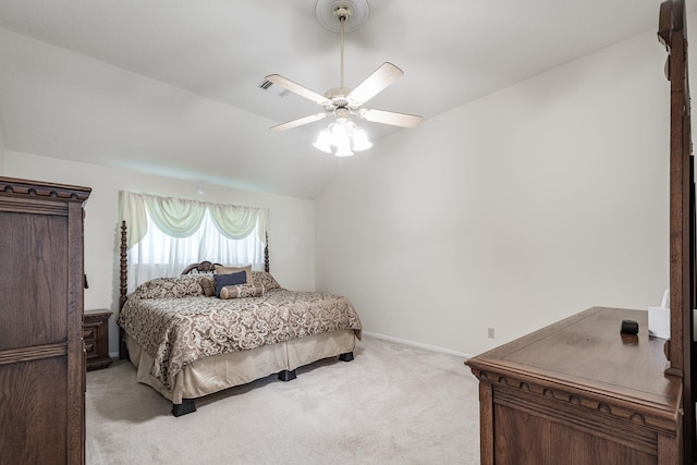 bedroom with a ceiling fan, vaulted ceiling, light colored carpet, and baseboards