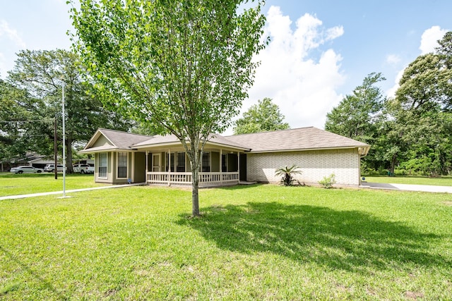 ranch-style house with a porch, a front lawn, and brick siding