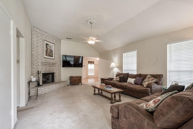 carpeted living room featuring visible vents, ceiling fan, lofted ceiling, and a brick fireplace