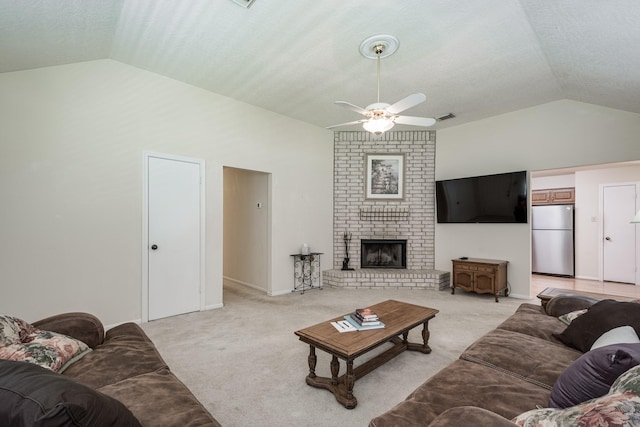 living room featuring a fireplace, ceiling fan, lofted ceiling, visible vents, and light colored carpet