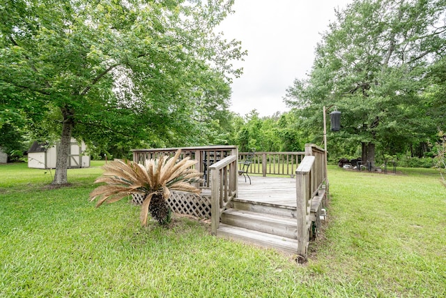 deck with a lawn, a storage shed, and an outbuilding