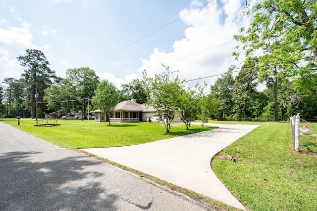 surrounding community with driveway and a lawn