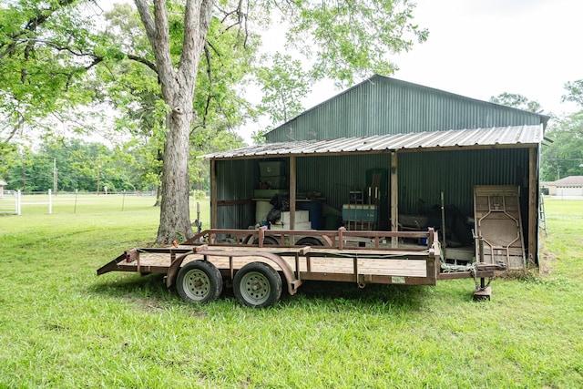 exterior space with an outdoor structure, a pole building, metal roof, and a yard
