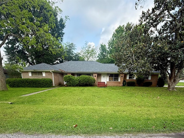 ranch-style home featuring a front yard and brick siding