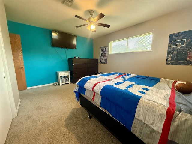 bedroom featuring baseboards, visible vents, a ceiling fan, and carpet