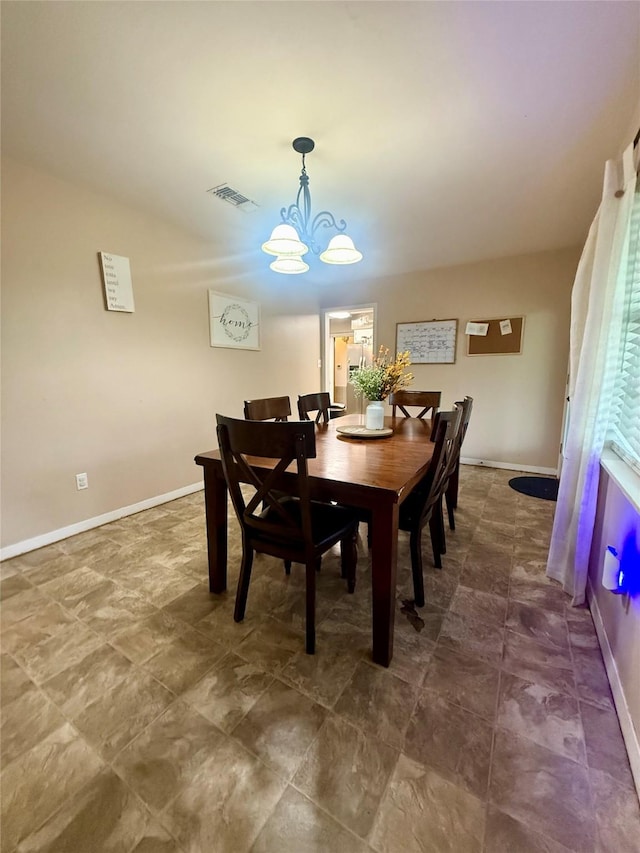 dining space with baseboards, visible vents, and a notable chandelier