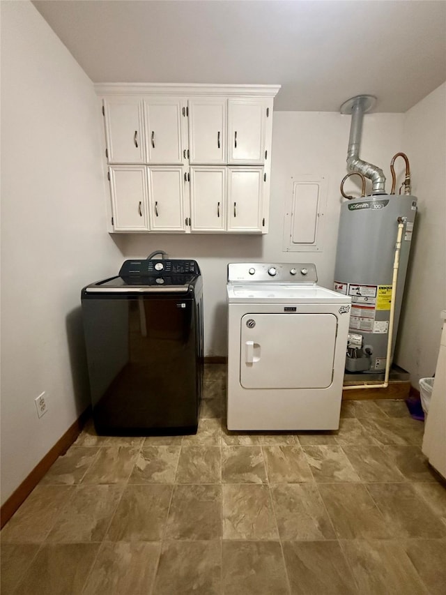 clothes washing area featuring baseboards, water heater, cabinet space, and washer and clothes dryer