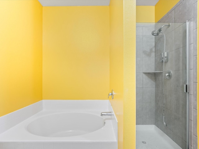 full bath featuring a shower stall and a bath