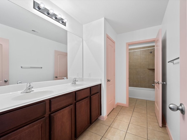 bathroom featuring tile patterned floors, visible vents, double vanity, and a sink