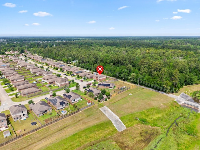 bird's eye view featuring a residential view and a forest view