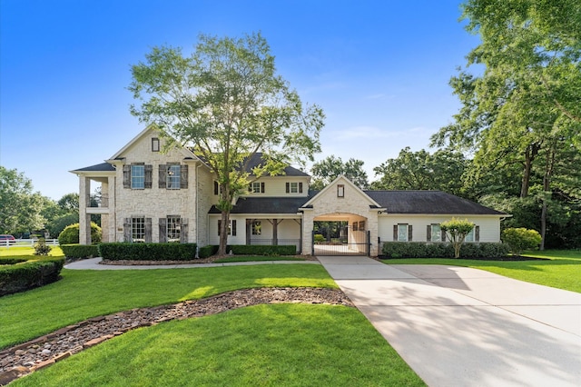 33802 Thousand Oaks Blvd, Magnolia, TX 77354 - view of front of house featuring stone siding, driveway, and a front yard