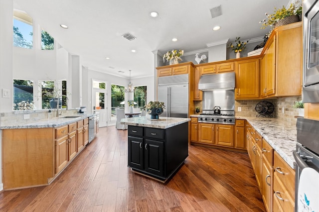 33802 Thousand Oaks Blvd, Magnolia, TX 77354 - kitchen featuring a center island, a sink, visible vents, appliances with stainless steel finishes, and ornamental molding