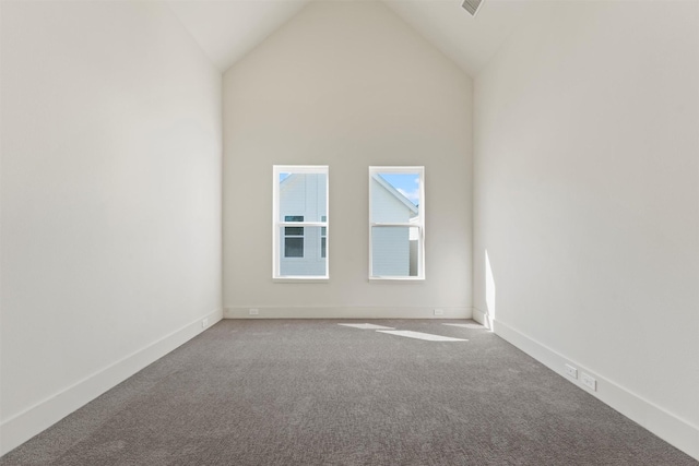 carpeted empty room with baseboards and lofted ceiling