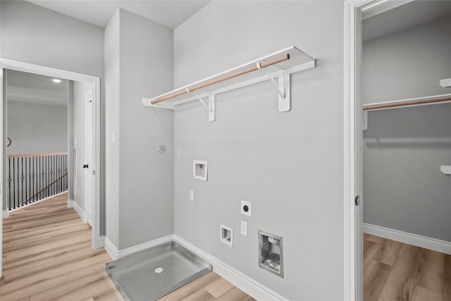 laundry area featuring washer hookup, electric dryer hookup, light wood-style floors, baseboards, and laundry area