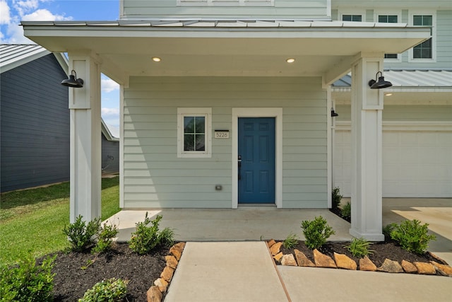 view of exterior entry featuring metal roof