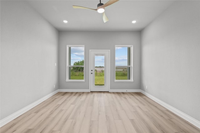 spare room featuring ceiling fan, recessed lighting, light wood finished floors, and baseboards