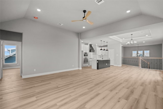 unfurnished living room with recessed lighting, visible vents, and ceiling fan with notable chandelier