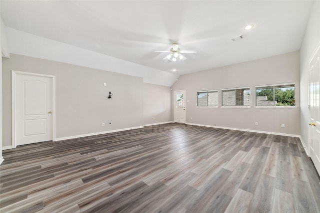 unfurnished living room with wood finished floors, a ceiling fan, visible vents, baseboards, and lofted ceiling