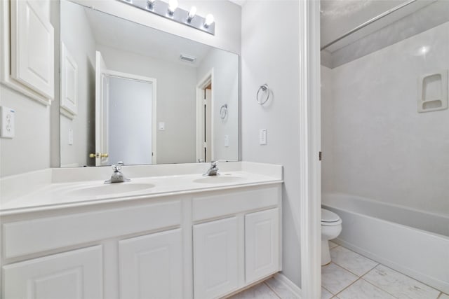 bathroom featuring double vanity, visible vents, toilet, and a sink