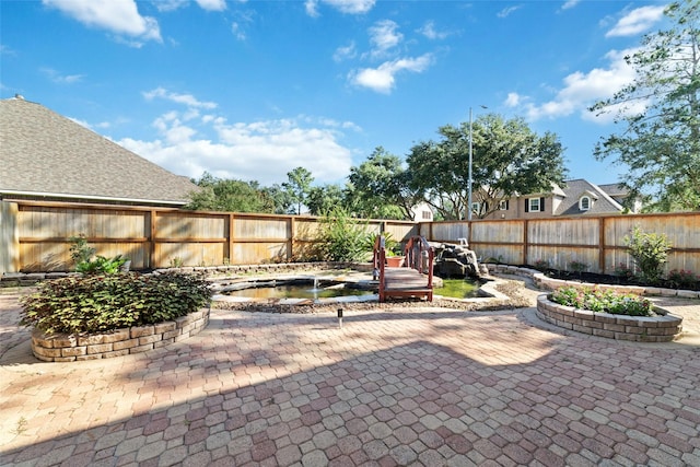 view of patio / terrace featuring a fenced backyard and a hot tub