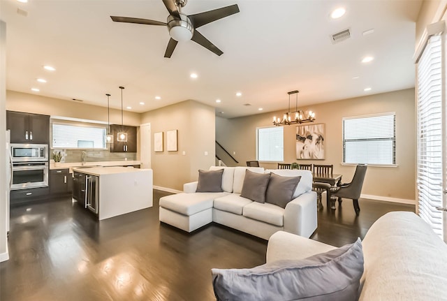 1812 Bingham St, Houston, TX 77007 - living room featuring recessed lighting, ceiling fan with notable chandelier, dark wood-style floors, and baseboards