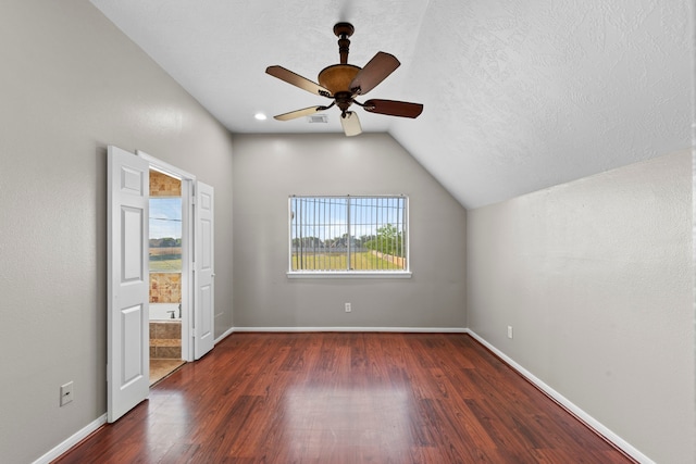 interior space featuring baseboards, wood finished floors, a ceiling fan, and lofted ceiling