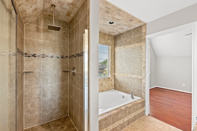 full bath featuring a garden tub, tile patterned flooring, a stall shower, and baseboards