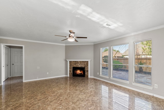 unfurnished living room featuring ornamental molding, ceiling fan, a stone fireplace, baseboards, and visible vents