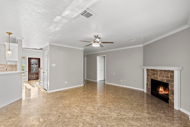 unfurnished living room featuring visible vents, a ceiling fan, crown molding, and a fireplace