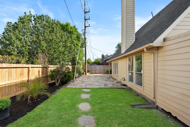 view of yard with a patio and a fenced backyard