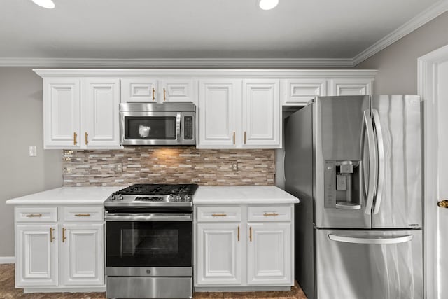 kitchen featuring appliances with stainless steel finishes, light countertops, crown molding, and backsplash