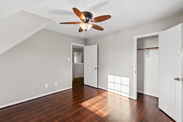 unfurnished bedroom with baseboards, wood finished floors, ceiling fan, and a closet