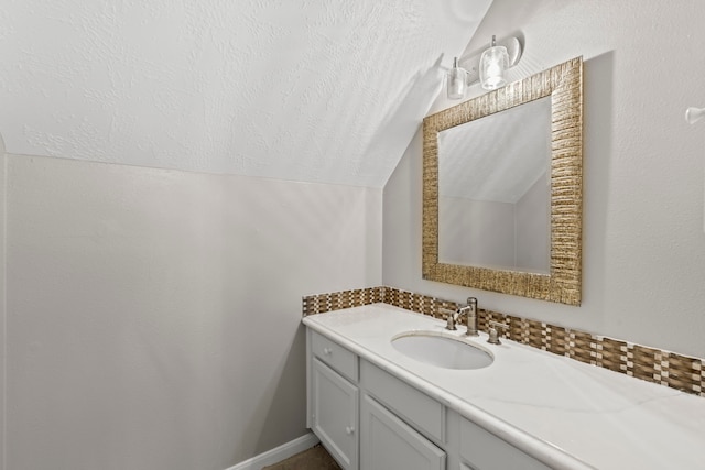 bathroom with vanity and vaulted ceiling