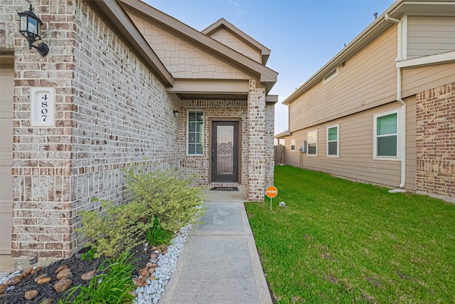4807 Purple Wisteria Ln, Spring, TX 77373 - view of exterior entry featuring brick siding and a lawn