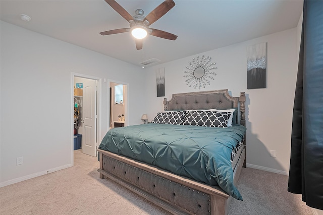 4807 Purple Wisteria Ln, Spring, TX 77373 - carpeted bedroom featuring a walk in closet, baseboards, ceiling fan, ensuite bath, and a closet