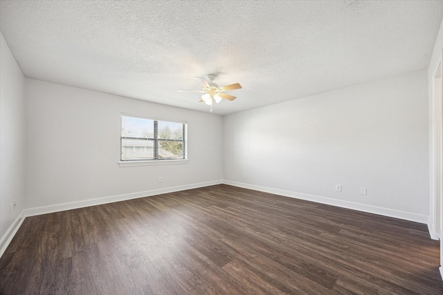 spare room featuring dark wood-style floors, baseboards, a ceiling fan, and a textured ceiling