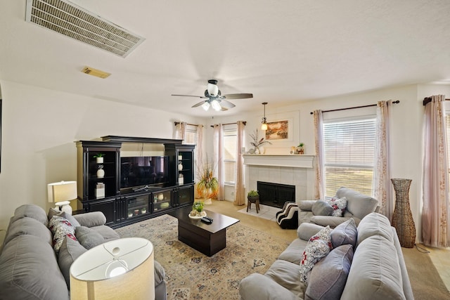 13823 Eldridge Garden Cir, Houston, TX 77083 - living area with a ceiling fan, a tile fireplace, visible vents, and carpet floors