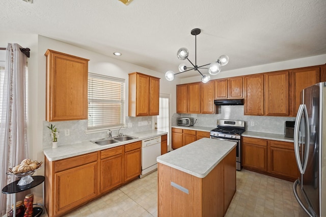 13823 Eldridge Garden Cir, Houston, TX 77083 - kitchen with under cabinet range hood, appliances with stainless steel finishes, light floors, and a sink