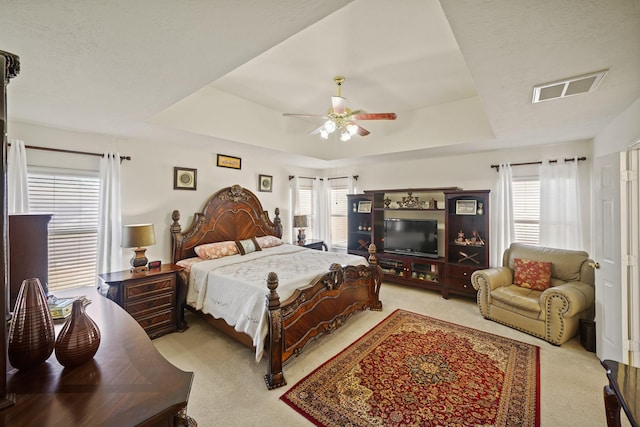 13823 Eldridge Garden Cir, Houston, TX 77083 - bedroom with light colored carpet, a raised ceiling, visible vents, and multiple windows