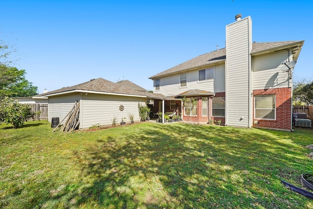 13823 Eldridge Garden Cir, Houston, TX 77083 - rear view of house with fence, brick siding, central AC, a yard, and a chimney