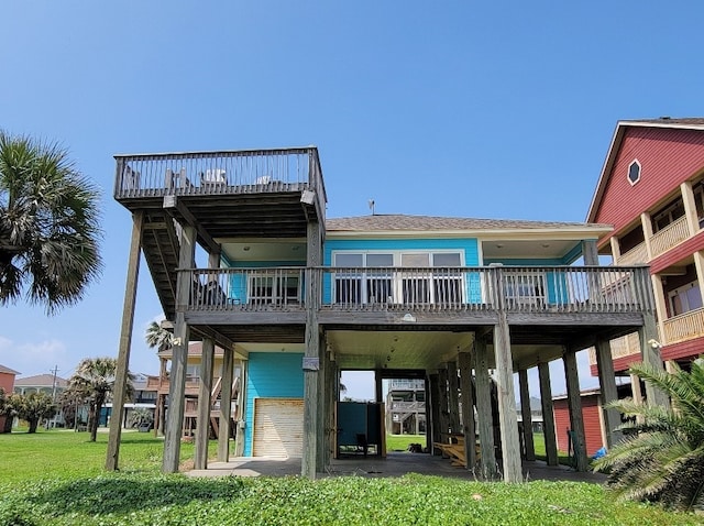 back of house with a deck and a carport