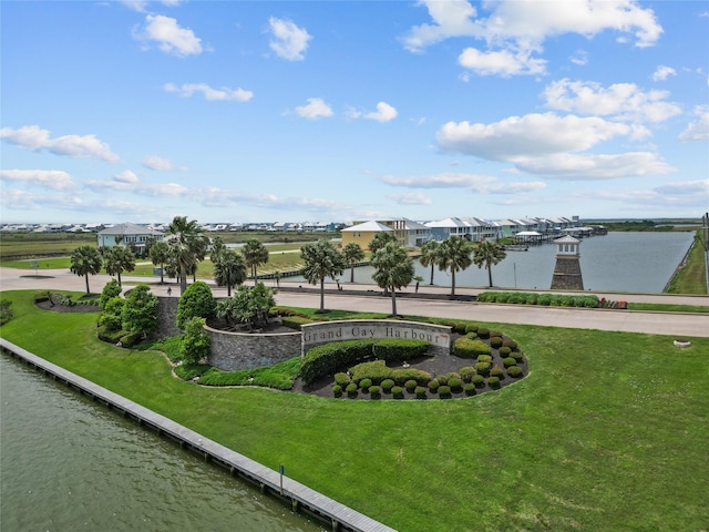 view of community with a yard and a water view