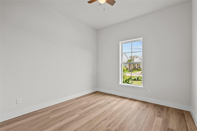 empty room with baseboards, light wood-style flooring, and ceiling fan