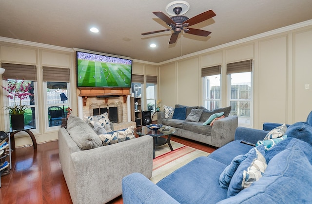 3114 E Ashfield Dr, Houston, TX 77082 - living area with a decorative wall, crown molding, ceiling fan, a fireplace with raised hearth, and wood finished floors