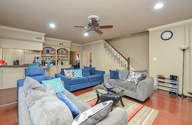3114 E Ashfield Dr, Houston, TX 77082 - living room featuring a ceiling fan, wood finished floors, stairs, crown molding, and recessed lighting