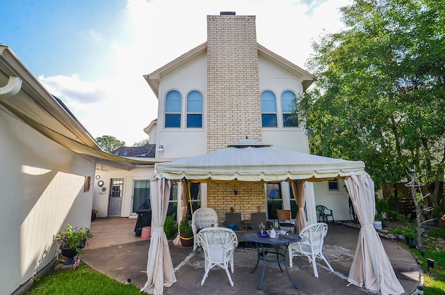 3114 E Ashfield Dr, Houston, TX 77082 - back of house with a gazebo, a patio area, a chimney, stucco siding, and fence